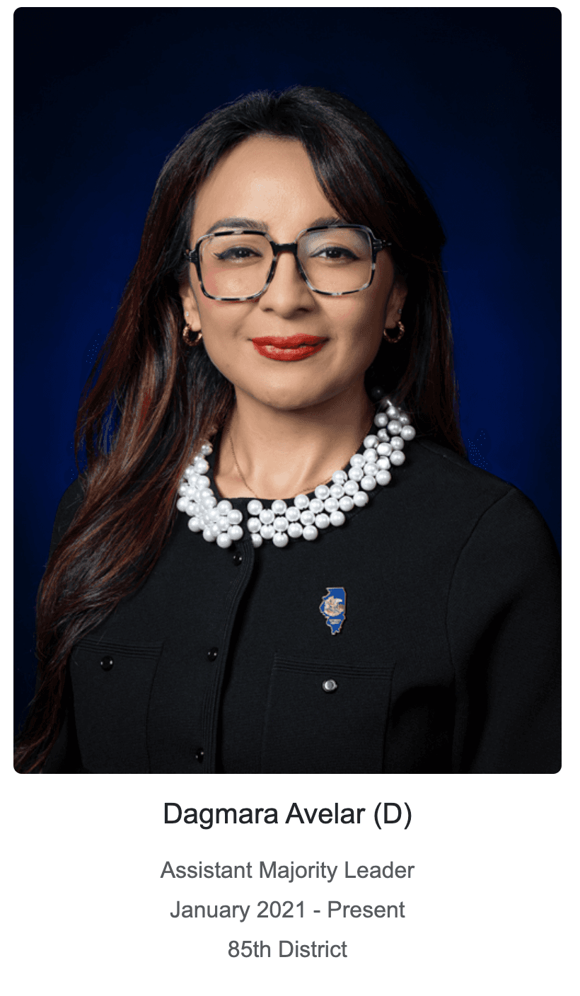 Dagmara Avelar, Assistant Majority Leader, wearing glasses, red lipstick, and a pearl collar.