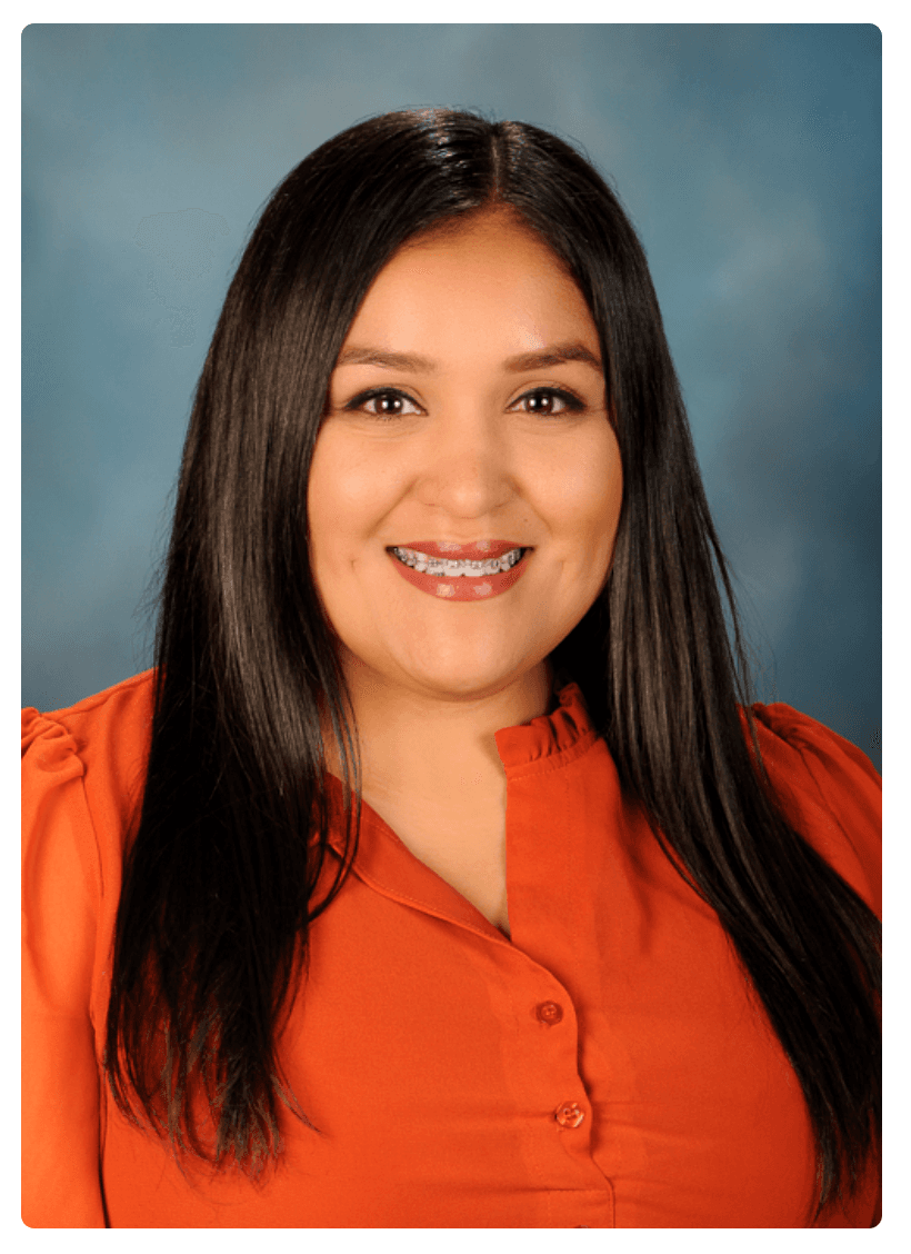 Smiling woman with long dark hair and braces wearing an orange blouse against blue background.